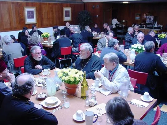 Attendees sharing a meal together at long tables
