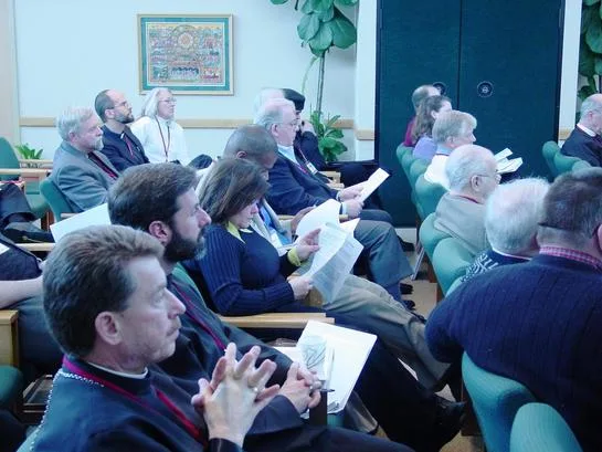 Wide view of attendees seated in the conference room