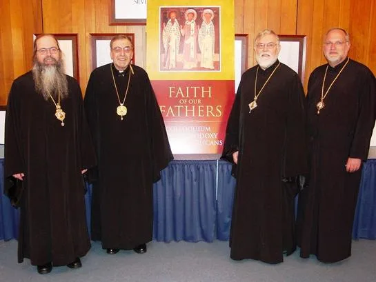 The hierarchs standing together in front of the conference sign