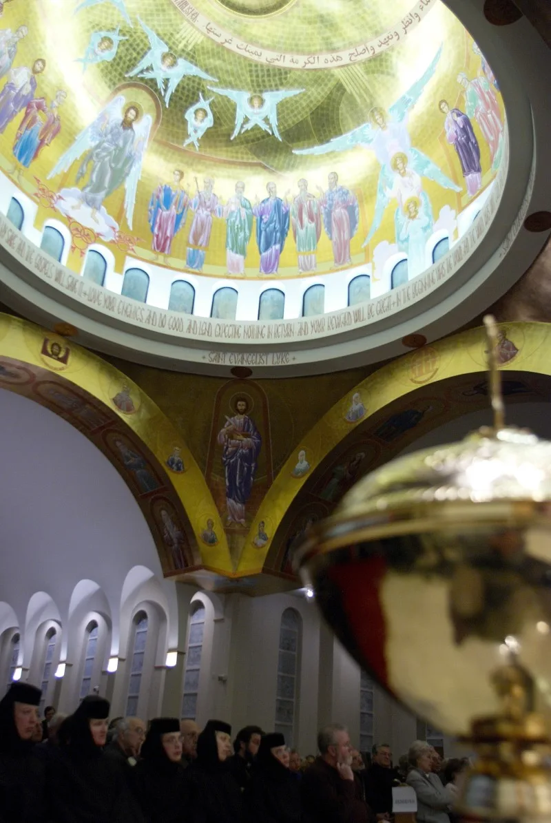 Monastics standing beneath the painted dome of St. George